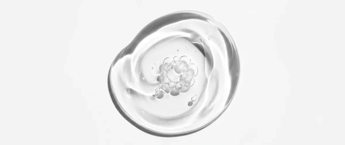 Swirl of clear, viscous glycerin on a white background