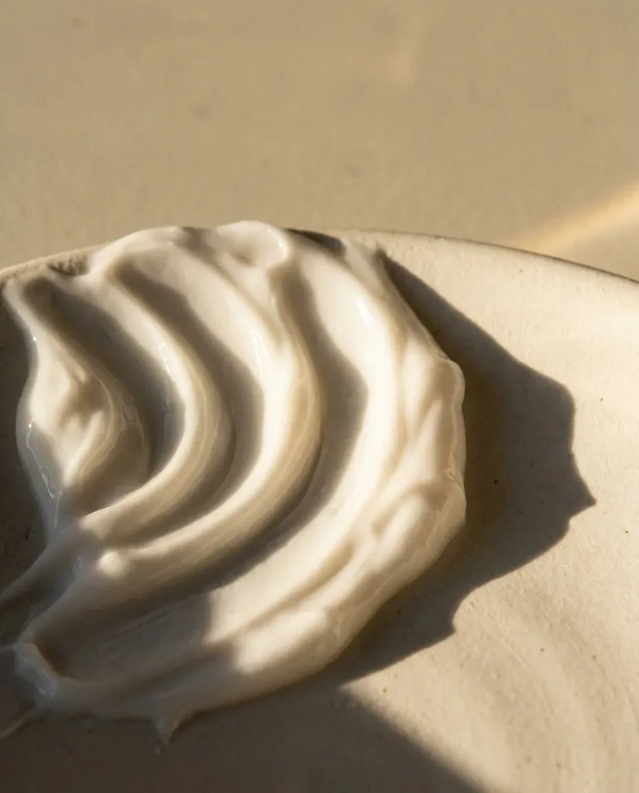 White cream swept in soft waves across a ceramic dish