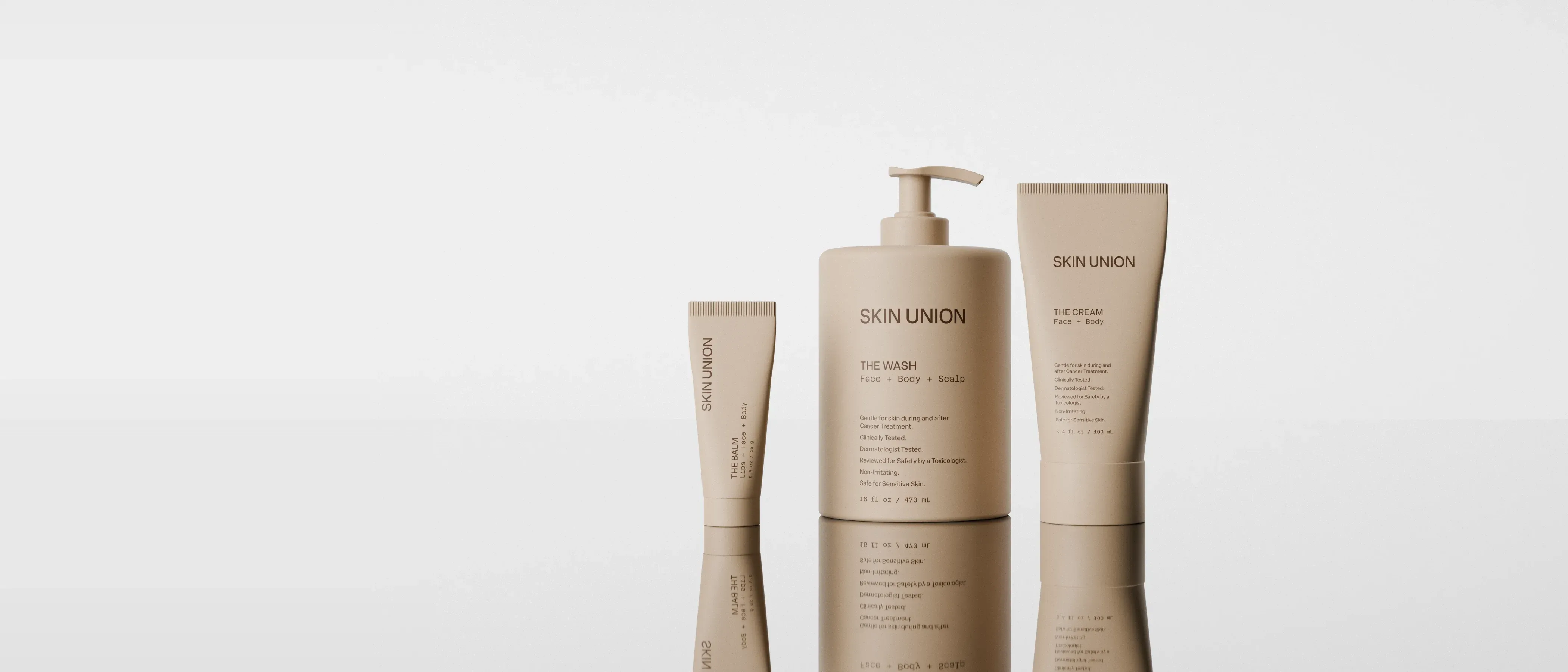 The Balm, The Wash and The Cream standing side by side on a reflective surface